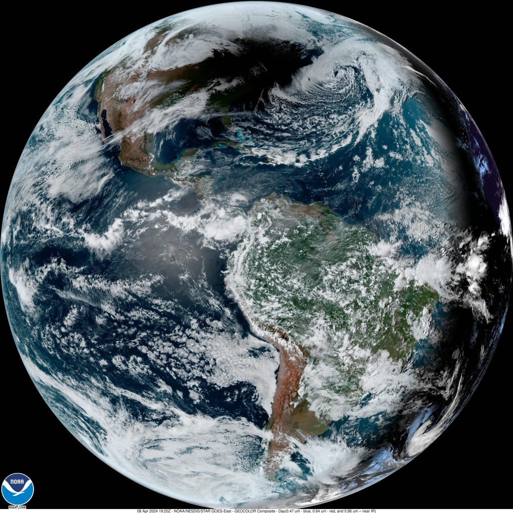 Photo compiled by NOAA from the GOES East satellite image of April 6, 2024 during the total solar eclipse. Image shows the shadow of the moon on the Earth as a dark patch with a few gray clouds.